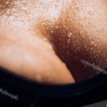 Wet breast. Womens breasts in a T-shirt. Beautiful female body. Big boobs. Sexy chest. Young girl. Summer heat sweat. Stock Photo hannatv 277560790