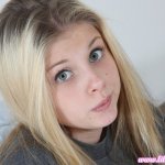 Pretty Lil Candy poses in a grey tshirt before fingering her tight pussy 16 photos